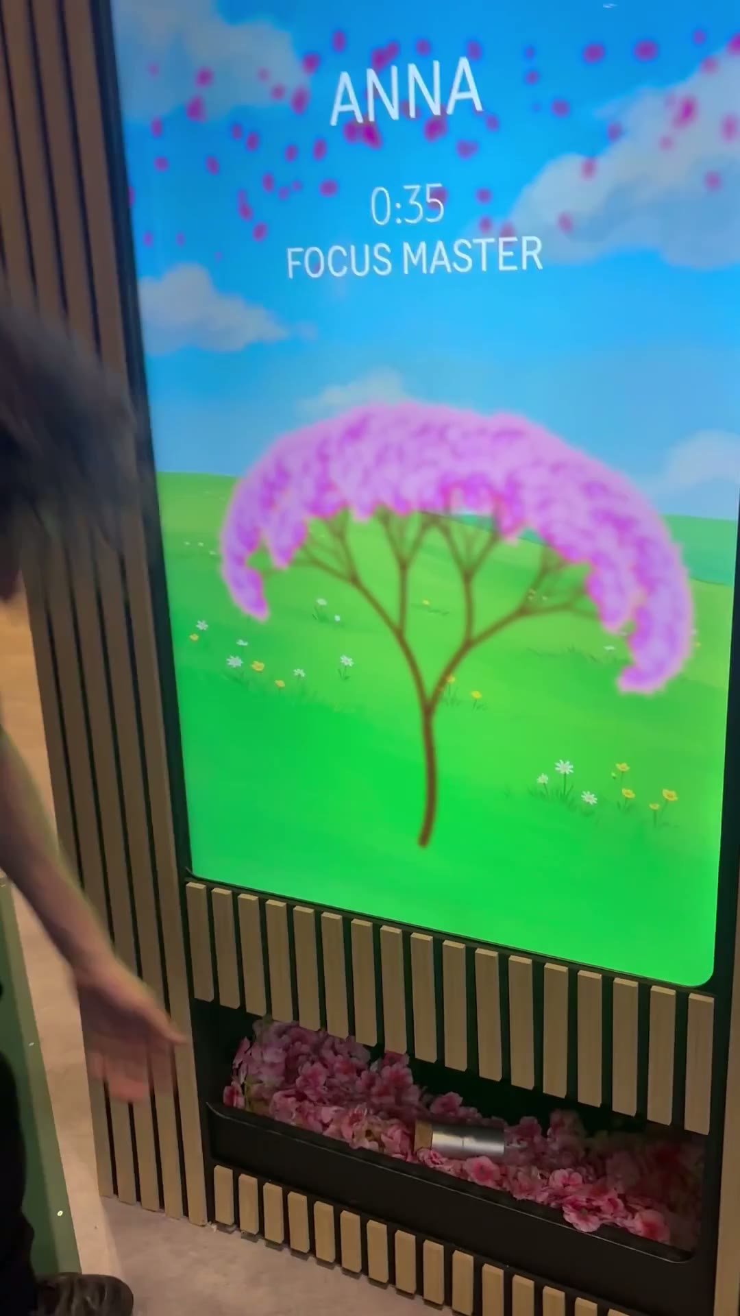 The vending screen at the end of a play: the players name, their time and the tree in full blossom.