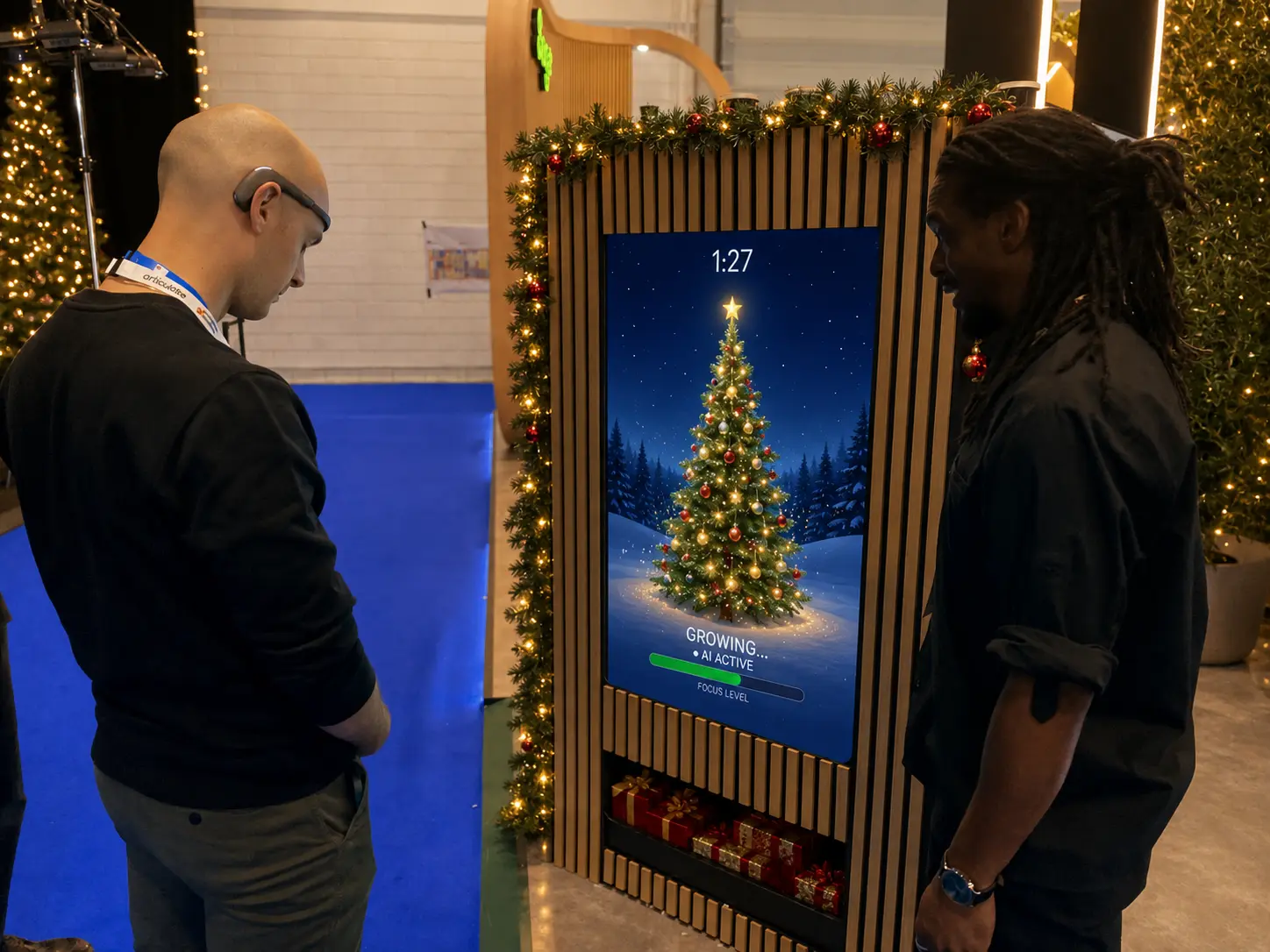 Two guests watching a Christmas tree grow on screen using an EEG headset