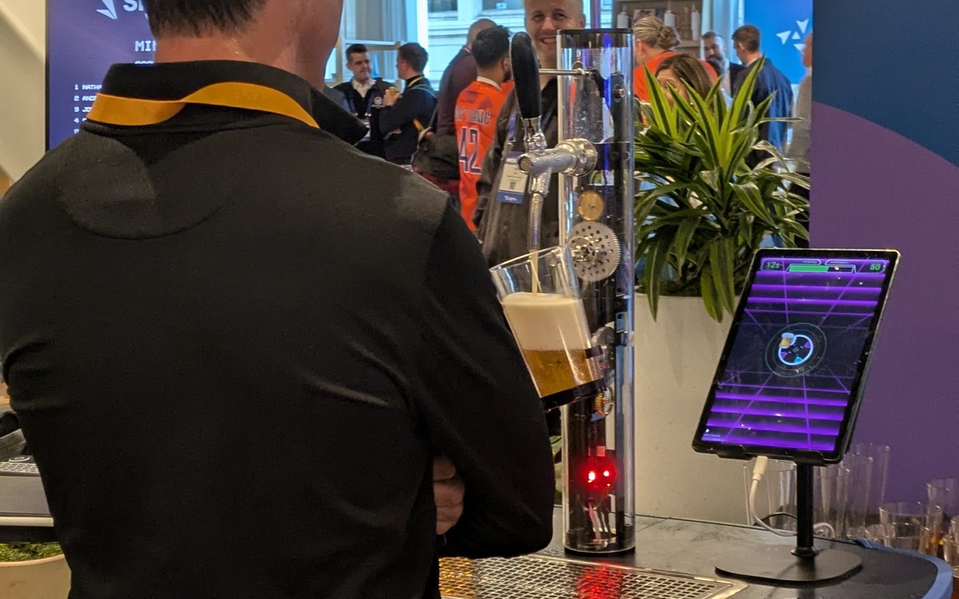 Homer pouring a drink for a guest at a live event