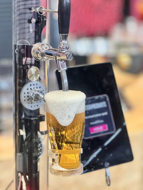 Beer pouring into the glass with the mechanism behind.